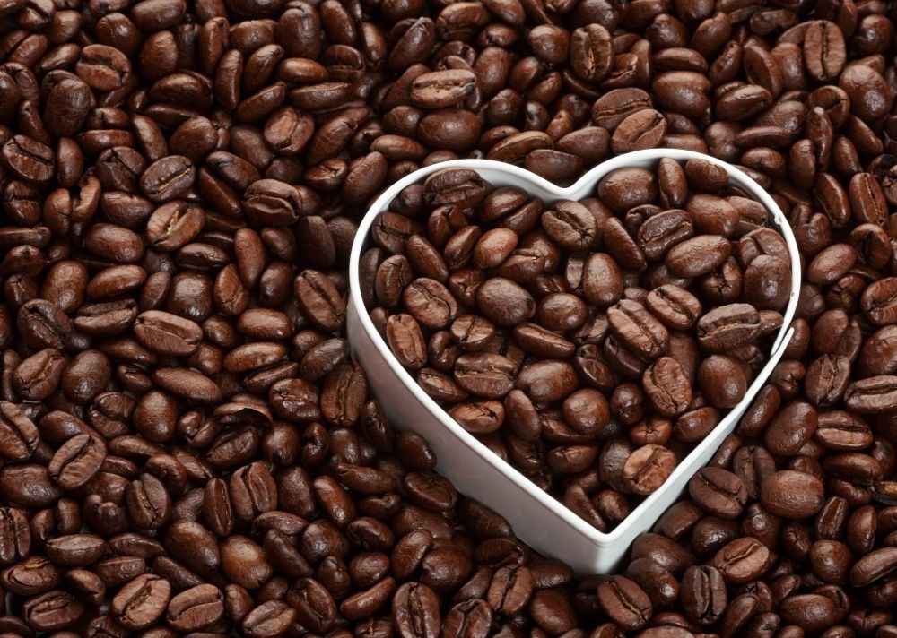 Coffee bean background with heart shape.  Coffee lovers concept.
