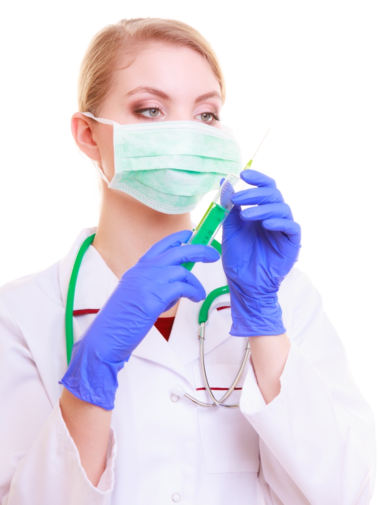 Woman in face mask and white lab coat. Doctor or nurse with syringe isolated. Medical person for health insurance.